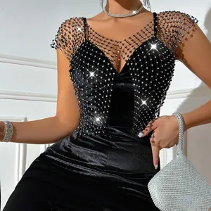 Close-up of sparkling rhinestone fishnet detailing on a sexy black velvet tank top vest
