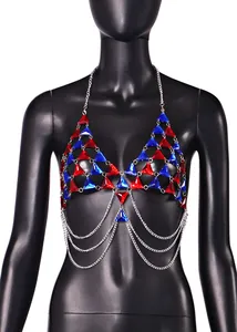 Macro detail of red and blue crystal triangle body chain top displayed on black mannequin
