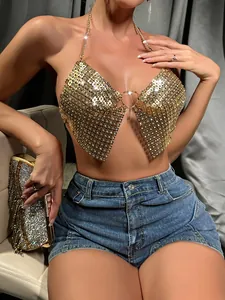 Close-up of a glamorous gold sequin metal halter top with a heart-shaped detail.