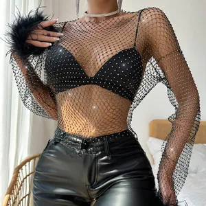 Detail view of the black fishnet top featuring sparkling rhinestones and feather cuffs.