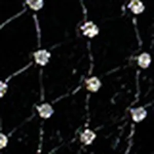 Close-up macro view of black fishnet mesh fabric with embedded shiny rhinestones.