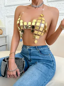 Close-up of gold acrylic geometric patchwork halter top with reflective finish.