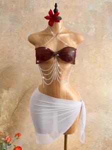 Macro view of burgundy rhinestone mesh bra body chain with elegant silver tassels