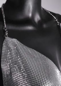 Close-up of the shimmering metallic mesh sequin texture on silver halter neck party dress