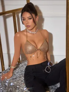 Detailed shot of a shimmering gold sequin halter top with dangling star fringe tassels