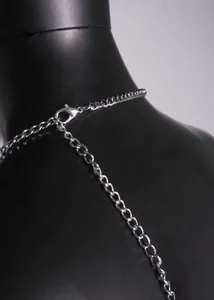 Detailed close-up view of silver metal chain strap and lobster clasp on halter neck dress.
