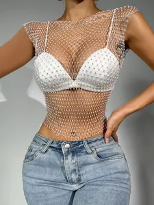 Close-up of white rhinestone fishnet crop top with sparkling crystals for clubwear style