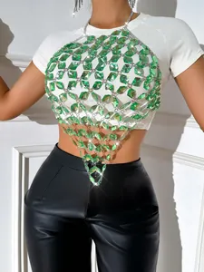 Close-up of green acrylic gemstone body chain vest over a white t-shirt