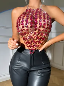 Detail of red acrylic gemstone halter top with silver metal chains and sparkles.
