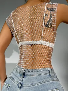 Detail of white mesh tank top featuring shimmering rhinestones over a white bikini top