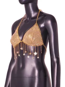 Detail view of gold rhinestone tassel crop top with star charms on black mannequin