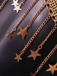 Close-up of gold chain vest featuring metallic stars and colorful rhinestones