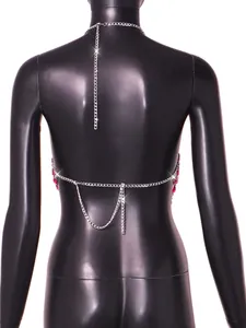 Detail view of the silver metal back chain with red acrylic gems on a black mannequin.