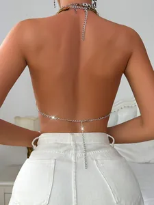 Detailed back view of a sexy silver link body chain accessory worn by a model in a bedroom