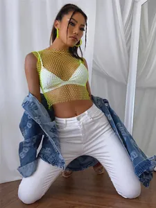Sexy neon yellow fishnet rhinestone mesh crop top styled with white denim jeans