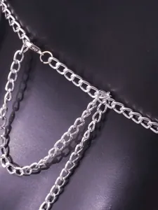 Close-up of silver metal body chain with lobster clasp for festival rave look