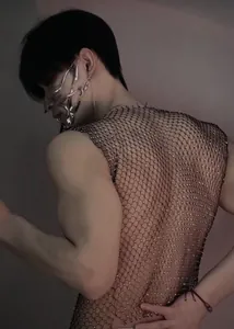 Close-up of black men's fishnet vest with sparkling rhinestones for nightclub wear