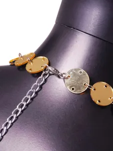 Detailed close-up of a gold acrylic body chain with silver metal clasp and links.