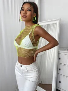 Detailed view of a neon yellow fishnet tank top with sparkling rhinestone embellishments