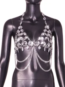 Detail of sparkling rhinestone body chain with silver chains on black mannequin.