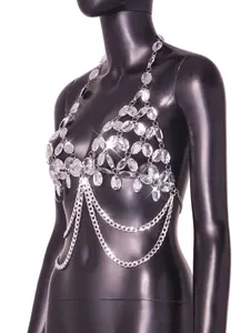 Detail view of an elegant sparkling rhinestone body chain top on a black mannequin.