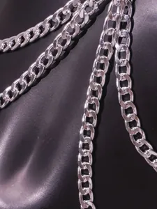 Macro detail of a thick silver metal body chain with high-polished punk links