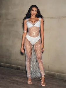 Full view of a white rhinestone fishnet beach cover-up dress on a model for a chic look