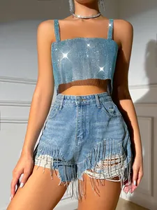 Detailed view of a sexy light blue rhinestone mesh crop top and fringe denim shorts.