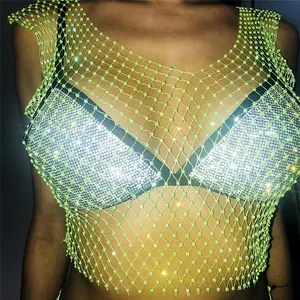 Detailed view of neon yellow mesh rave top featuring sparkling rhinestone embellishments