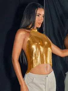 Detailed macro view of gold metallic sequin texture on halter top vest