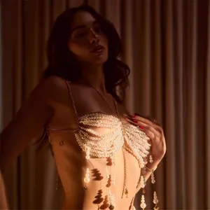 Close-up detail of a luxurious multi-layered pearl beaded body chain bra and chest jewelry