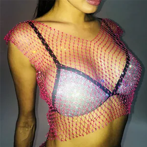 Close-up of pink fishnet mesh crop top with sparkling rhinestones and silver sequins