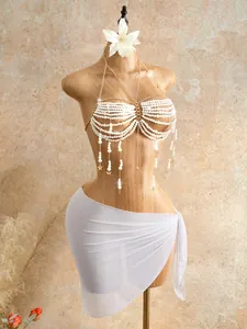 Intricate detail view of elegant white pearl beaded halter body chain on mannequin