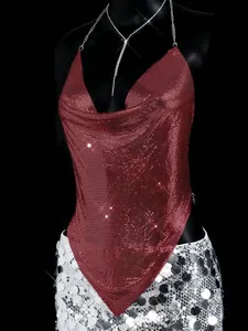 Detailed view of burgundy metallic mesh halter top and silver sequined skirt