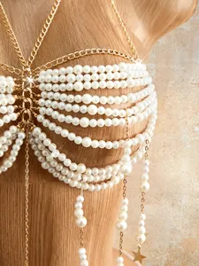 Macro detail of luxury multi-layered pearl beaded body chain bra with gold star charm