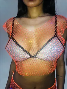 Detail view of neon orange rhinestone mesh top with sexy fishnet hollow design.