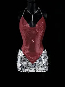 Detailed view of red metallic mesh halter top and silver sequined mini skirt on mannequin