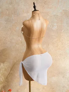 Back view of elegant gold beaded body chain paired with white sheer sarong wrap skirt