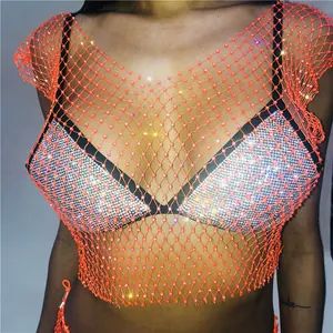 Close-up of orange fishnet top with sparkling rhinestones and silver sequins