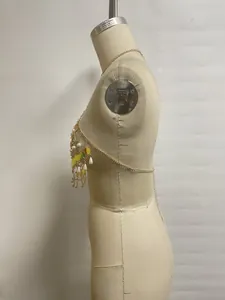 Side view detail showing the intricate gold body chain with pearls and sequins for bikini