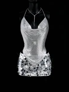 Detailed view of silver metallic mesh halter top and sequined mini skirt on mannequin.