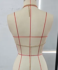 Minimalist gold halter body chain bra jewelry accessory shown on a dress form mannequin.