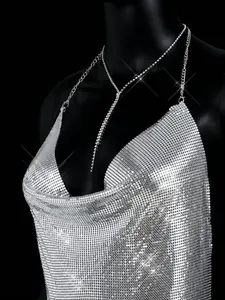 Detailed view of the sparkling silver metallic sequin mesh fabric on a sexy halter top