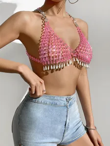 Close-up of pink beaded halter top with pearl fringe in a stylish nightclub look
