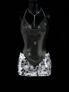 Sexy black metal mesh deep V halter top and silver sequin mini skirt on mannequin display.
