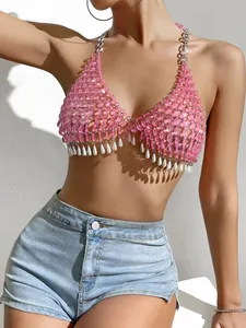 Macro detail of pink gemstone and pearl halter top designed for party and nightclub wear