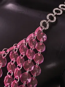 Close-up detail of pink translucent octagonal beads and rhinestone chain for halter top
