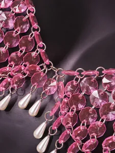 Macro detail showing pink hexagonal beads and teardrop pearls on a sexy halter top
