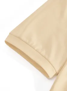 Close-up detail of the ribbed sleeve cuff and textured fabric on an apricot men's Polo shirt