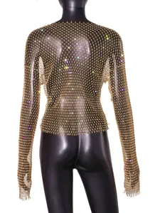 Close-up of gold fishnet top with sparkling colorful rhinestones on a mannequin